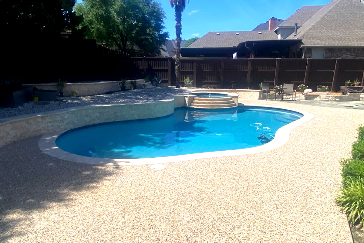 A pool with travertine pool tiles after pool renovation my Morton Pool Solutions